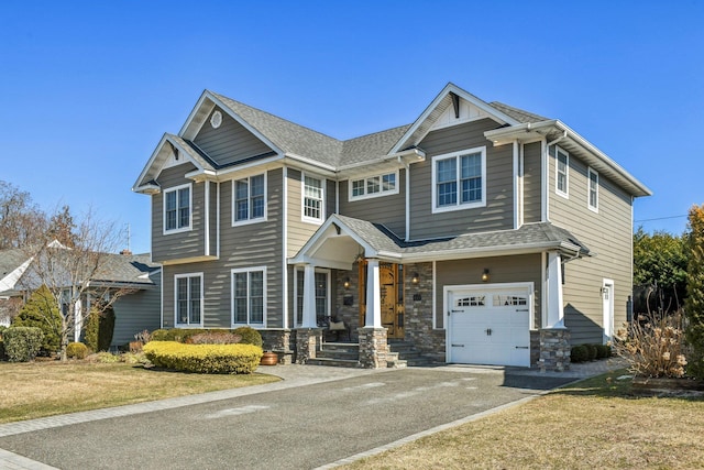 view of front of home featuring a garage, stone siding, roof with shingles, and aphalt driveway