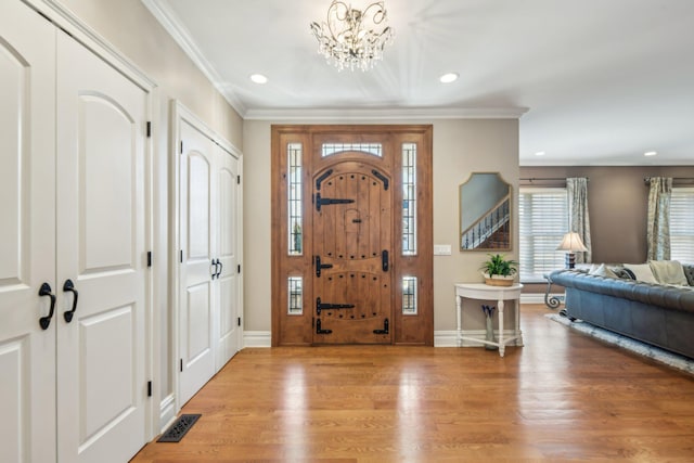 foyer entrance with ornamental molding, recessed lighting, wood finished floors, and baseboards