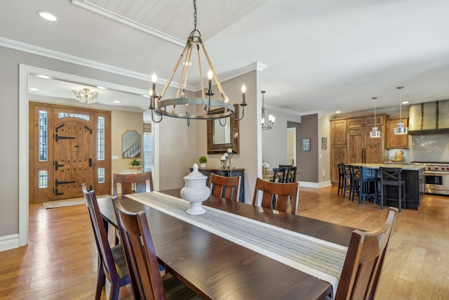 dining area with light wood-style flooring, ornamental molding, and recessed lighting