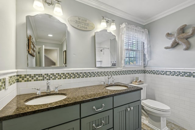 bathroom with toilet, ornamental molding, a shower, and a sink