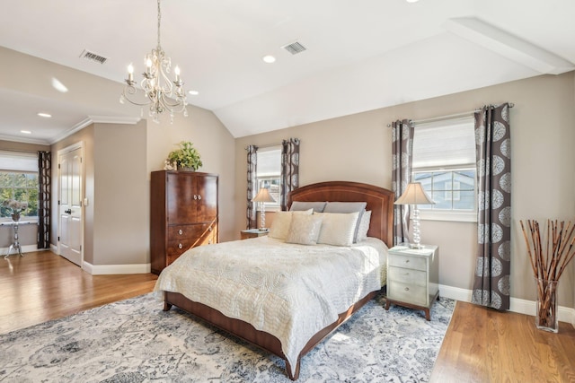 bedroom with visible vents, baseboards, and wood finished floors