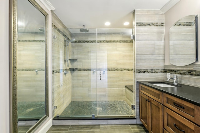 full bathroom featuring a shower stall, tasteful backsplash, and vanity