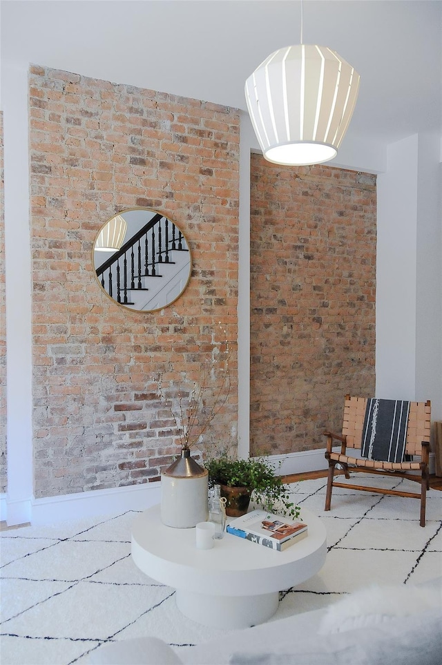 unfurnished dining area featuring brick wall