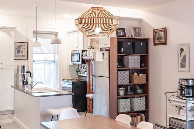 tiled dining room featuring sink