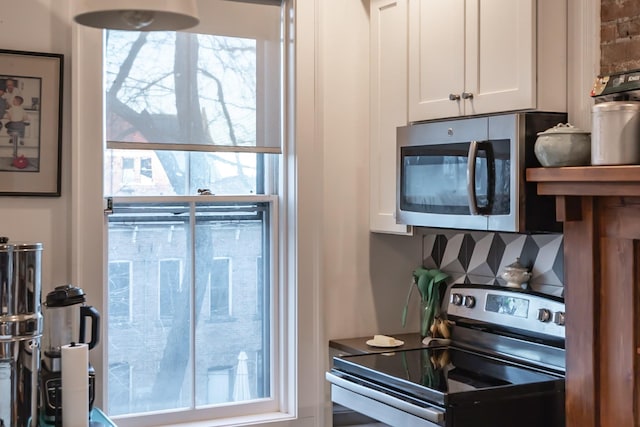 kitchen with white cabinetry and appliances with stainless steel finishes