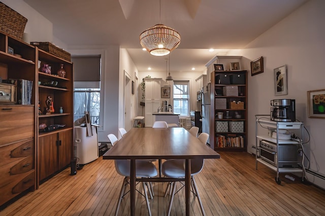 dining space with light hardwood / wood-style flooring