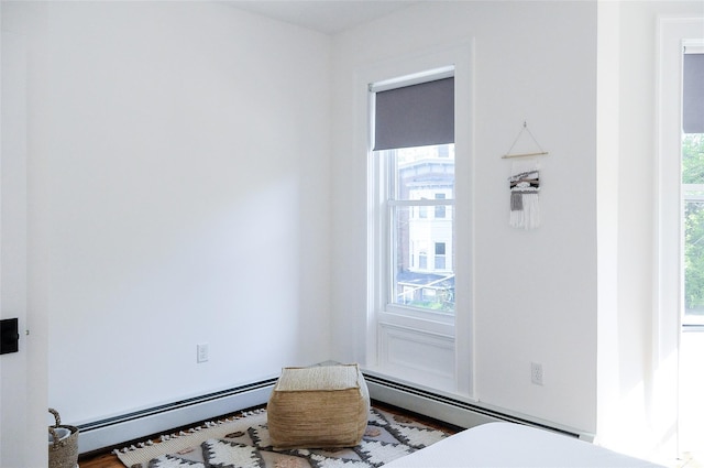 bedroom featuring hardwood / wood-style flooring and a baseboard radiator