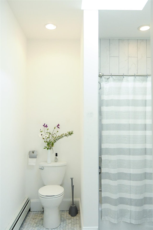 bathroom featuring curtained shower, baseboard heating, and toilet