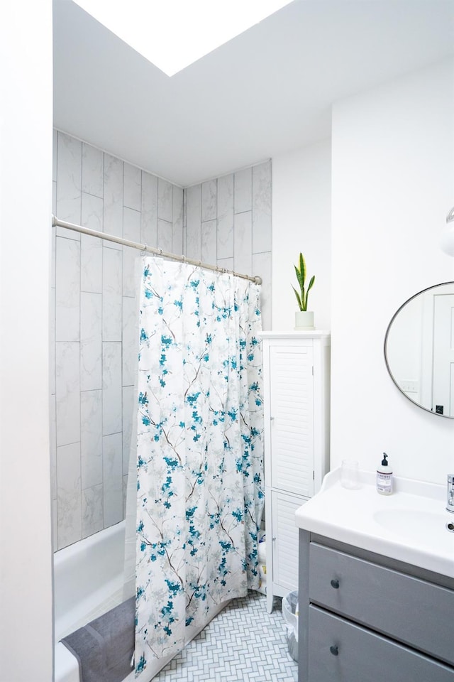 bathroom featuring tile patterned floors, vanity, and shower / bath combo with shower curtain