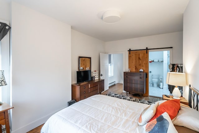 bedroom featuring dark wood-type flooring, a baseboard radiator, and connected bathroom