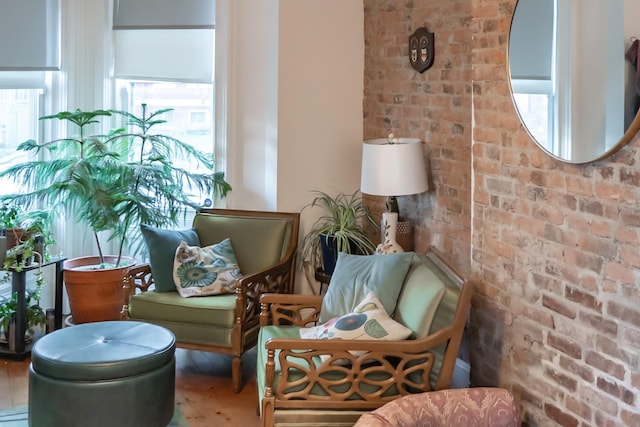 living area featuring brick wall