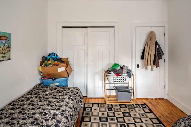 bedroom with wood-type flooring and a closet