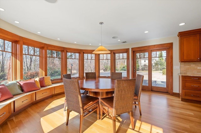 dining space featuring light hardwood / wood-style flooring and french doors