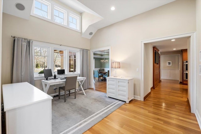 office space featuring light hardwood / wood-style flooring and a high ceiling