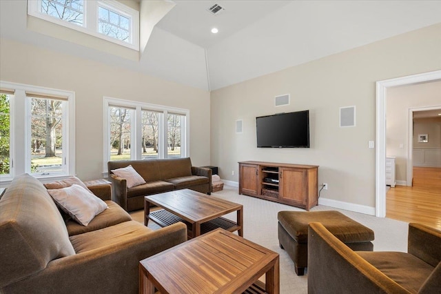 living room featuring high vaulted ceiling