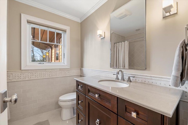 bathroom with tile walls, vanity, crown molding, toilet, and tile patterned floors