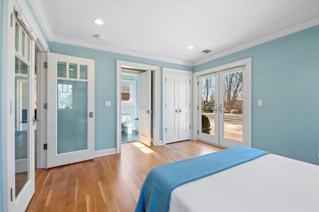 bedroom with ornamental molding, french doors, multiple windows, and access to outside