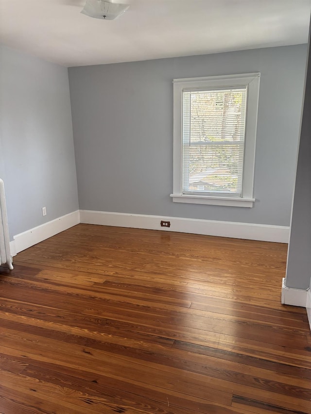 spare room featuring dark hardwood / wood-style floors