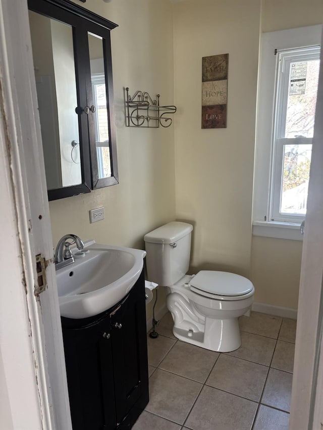 bathroom featuring vanity, tile patterned flooring, and toilet