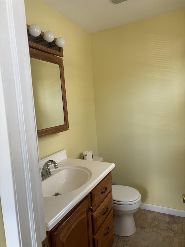 bathroom featuring vanity, tile patterned flooring, and toilet