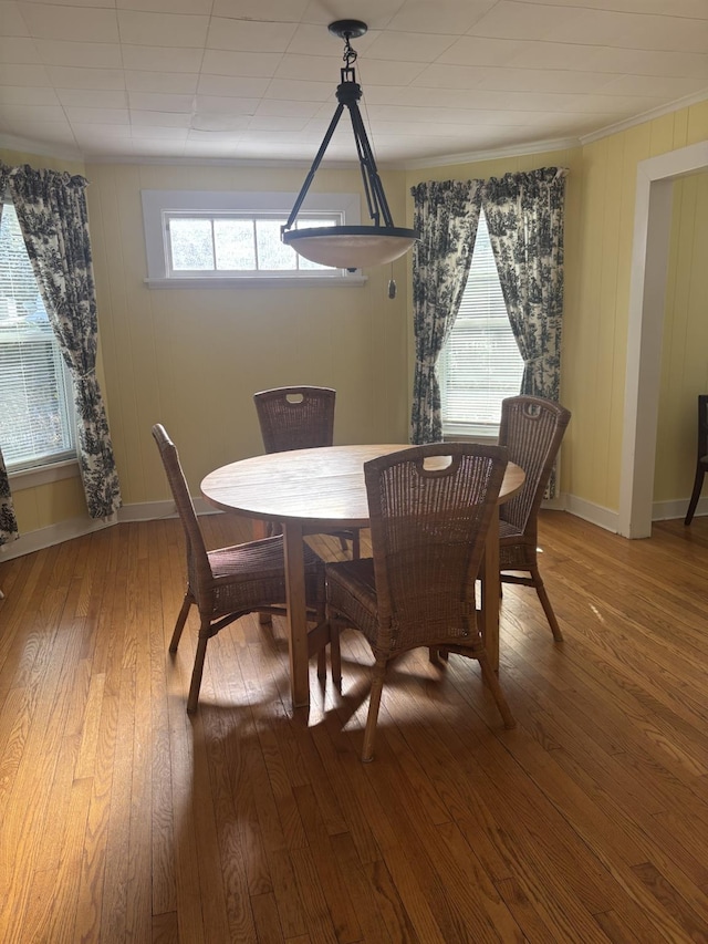 dining space with wood-type flooring