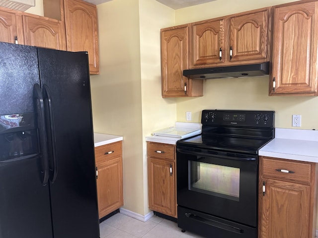 kitchen with light tile patterned floors and black appliances