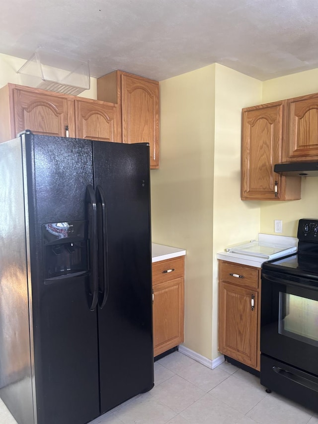 kitchen featuring black appliances and light tile patterned flooring