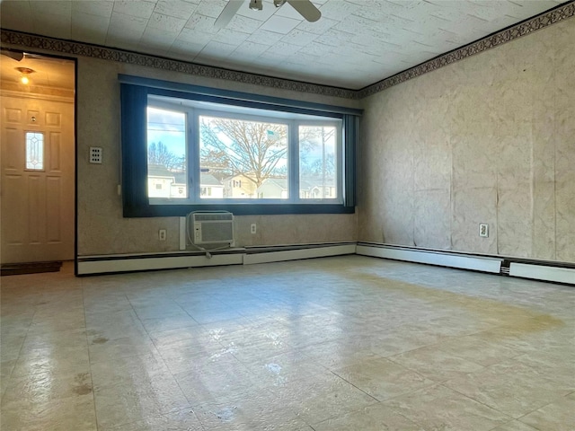 unfurnished room with a ceiling fan and baseboard heating