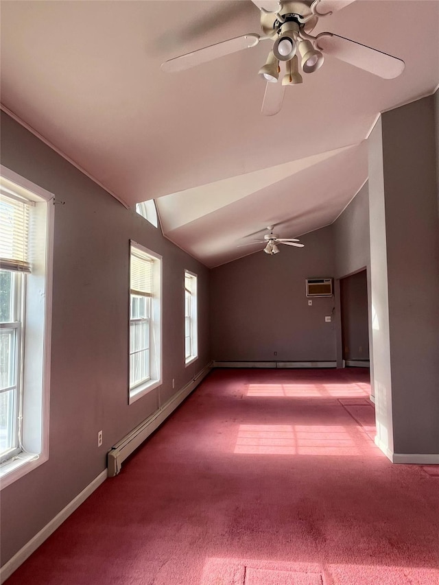 unfurnished room with light colored carpet, a baseboard radiator, a wall mounted air conditioner, vaulted ceiling, and a healthy amount of sunlight