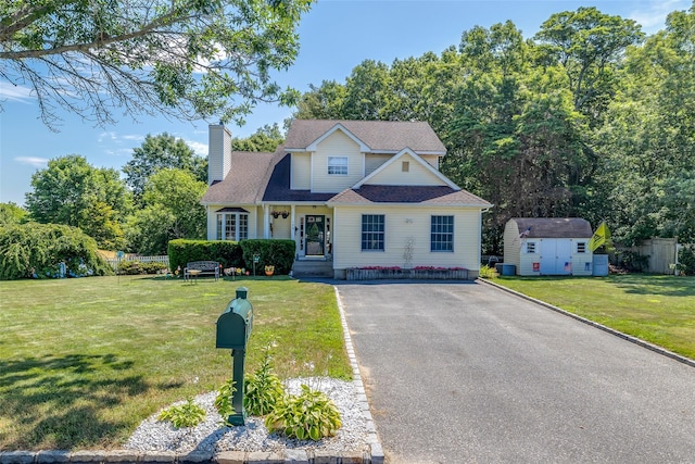 106 Williams Way S, Baiting Hollow, NY 11933 - traditional-style house with a shed, a chimney, a front lawn, and asphalt driveway