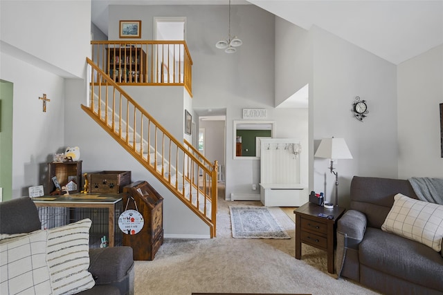 106 Williams Way S, Baiting Hollow, NY 11933 - carpeted living room featuring high vaulted ceiling, stairway, and a chandelier