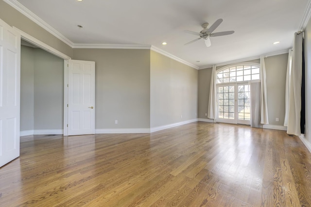 spare room with ceiling fan, recessed lighting, wood finished floors, baseboards, and crown molding