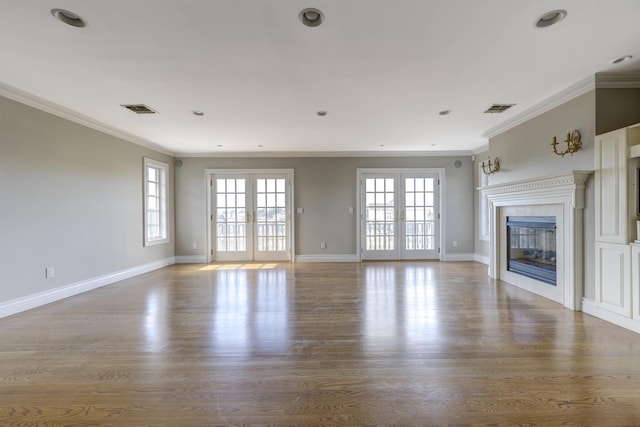 unfurnished living room with french doors, visible vents, and a fireplace