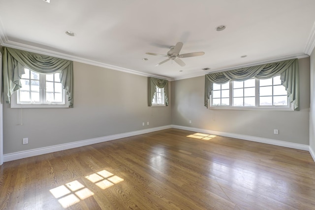 unfurnished room featuring baseboards, ornamental molding, ceiling fan, and wood finished floors