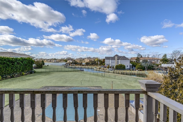 view of yard featuring a water view and fence