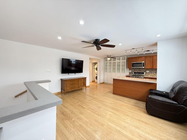 living room featuring ceiling fan and light wood-type flooring