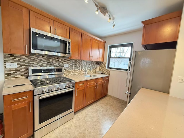 kitchen featuring tasteful backsplash, appliances with stainless steel finishes, and sink