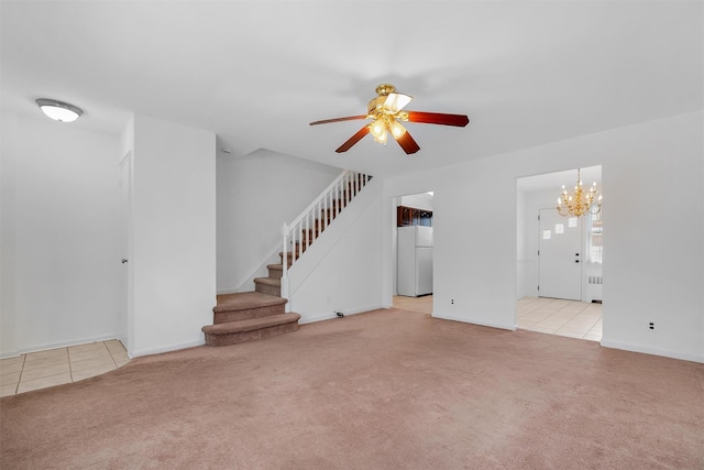 unfurnished living room featuring light colored carpet and ceiling fan with notable chandelier