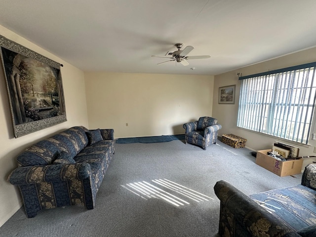 living area featuring carpet flooring and a ceiling fan