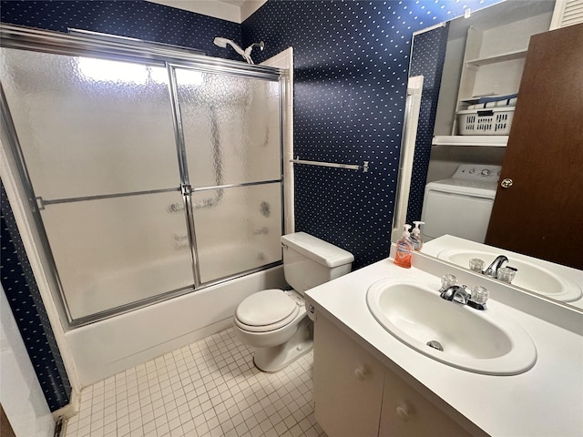 bathroom featuring toilet, wallpapered walls, tile patterned flooring, and washer / clothes dryer