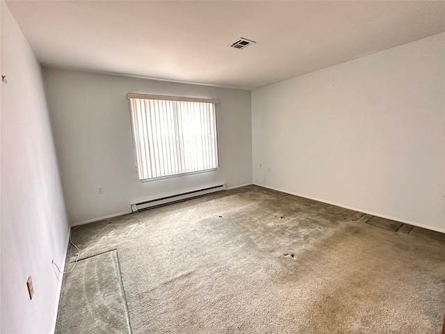 empty room featuring visible vents, a baseboard heating unit, and carpet flooring