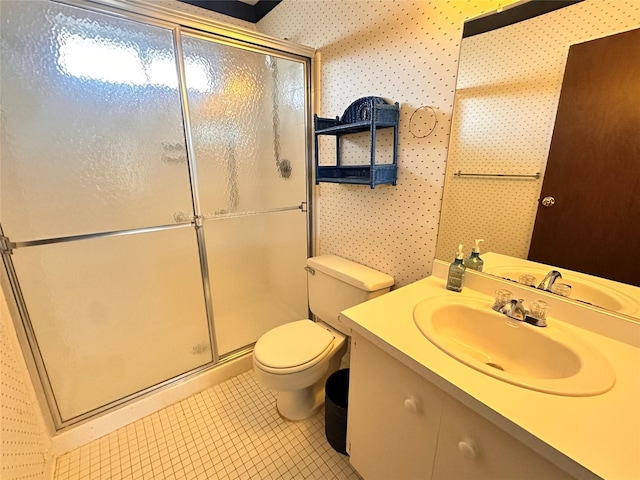 full bathroom featuring vanity, a shower stall, toilet, and wallpapered walls