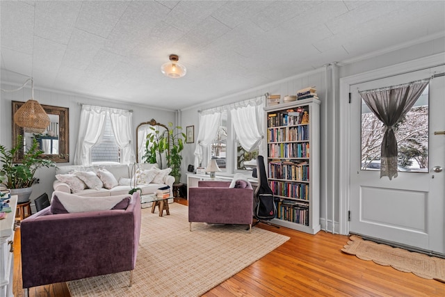 living room with crown molding, hardwood / wood-style flooring, and a textured ceiling