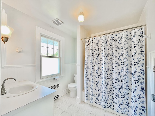 bathroom with tile patterned flooring, vanity, and toilet