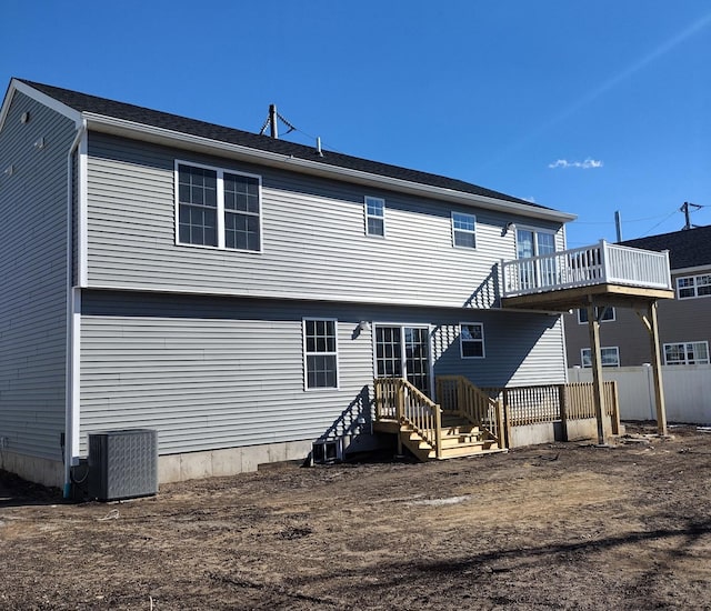 back of house with central air condition unit