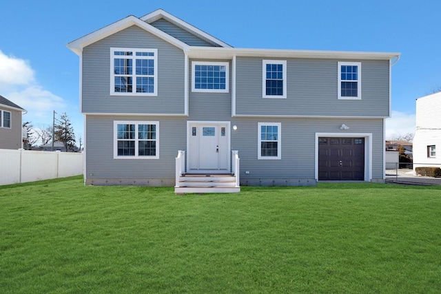 view of front of property featuring an attached garage, fence, and a front lawn