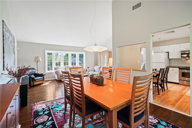 dining area featuring visible vents and wood finished floors