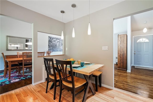 dining space featuring baseboards and wood finished floors