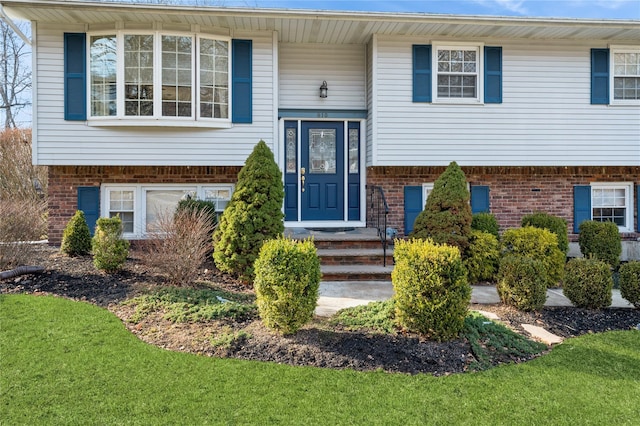 split foyer home with brick siding