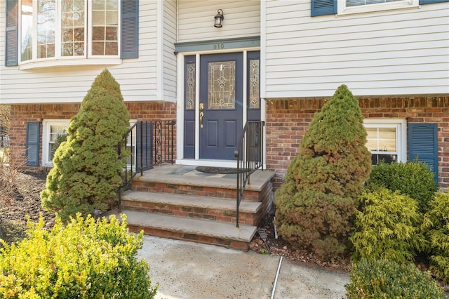 view of exterior entry with brick siding